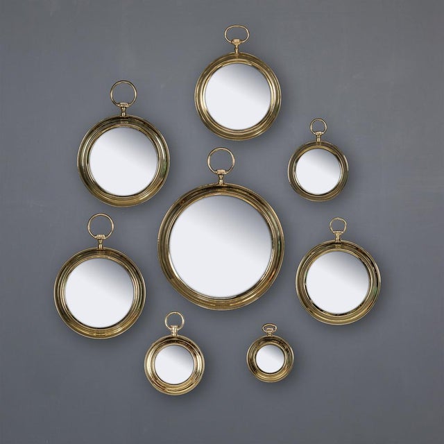 A collection of eight pocket watch shaped mirrors, this design immortalised by Fornasetti has not lost its impact since...