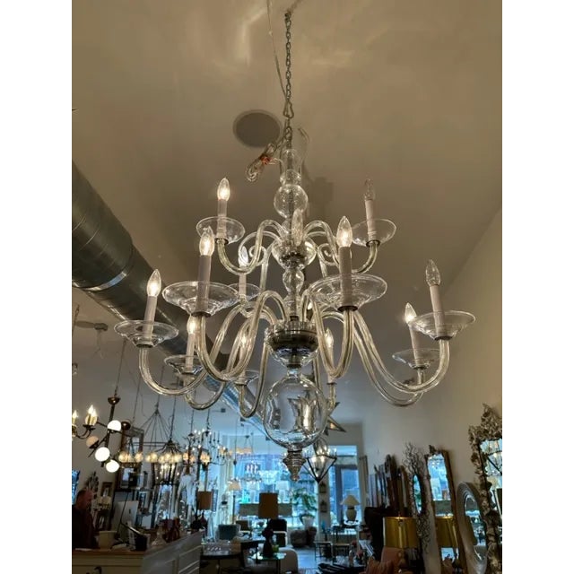 This is a handblown 12 arm chandelier by Preciosa. With 2 tiers this fixture is generous in size but has a quiet presence....