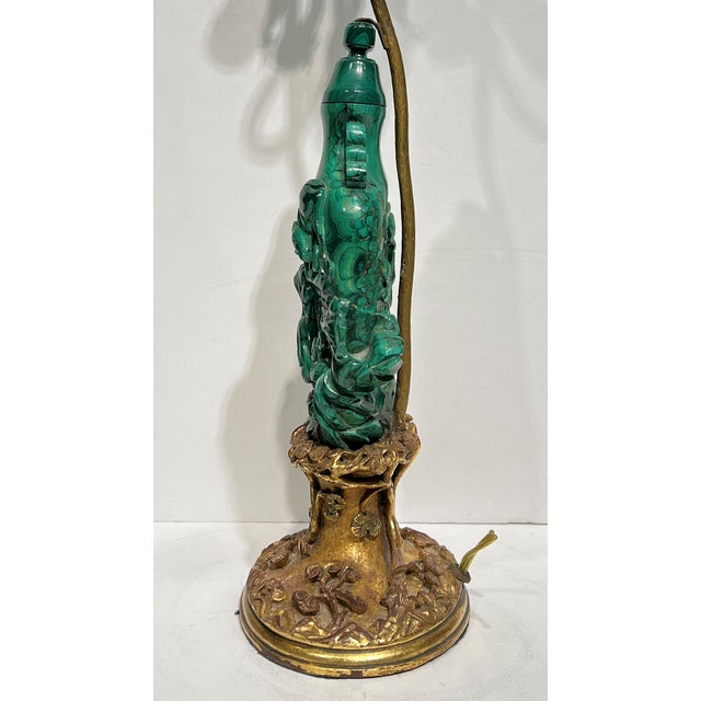 Antique (late 19th to early 20th century) table lamp crafted from carved Malachite with carved giltwood base, with its...