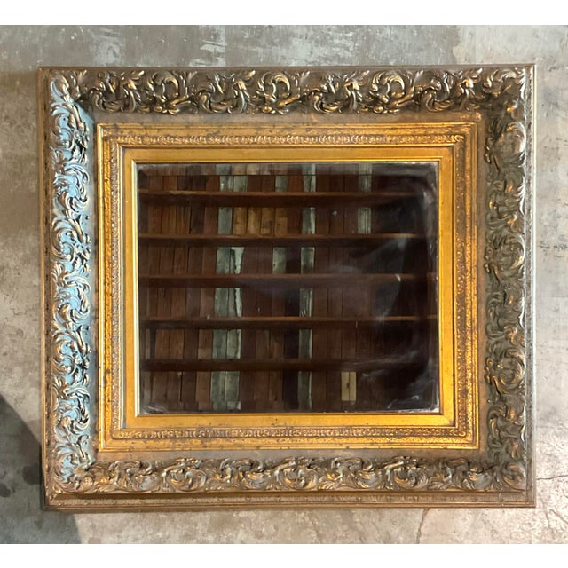 This stunning vintage wall mirror embodies the opulence of Rococo design, featuring a masterfully carved frame finished in...