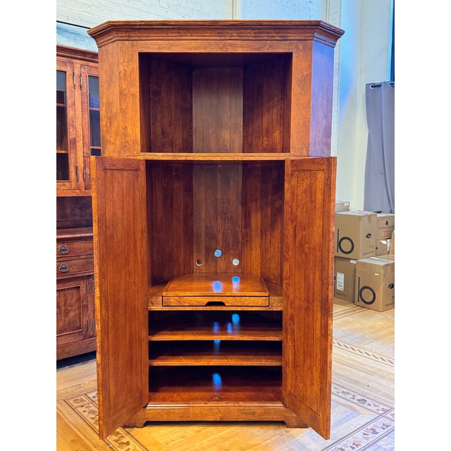 Design Plus Gallery presents the Bausman & Company Corner Media Armoire. Constructed in wood with a light fruitwood tone...