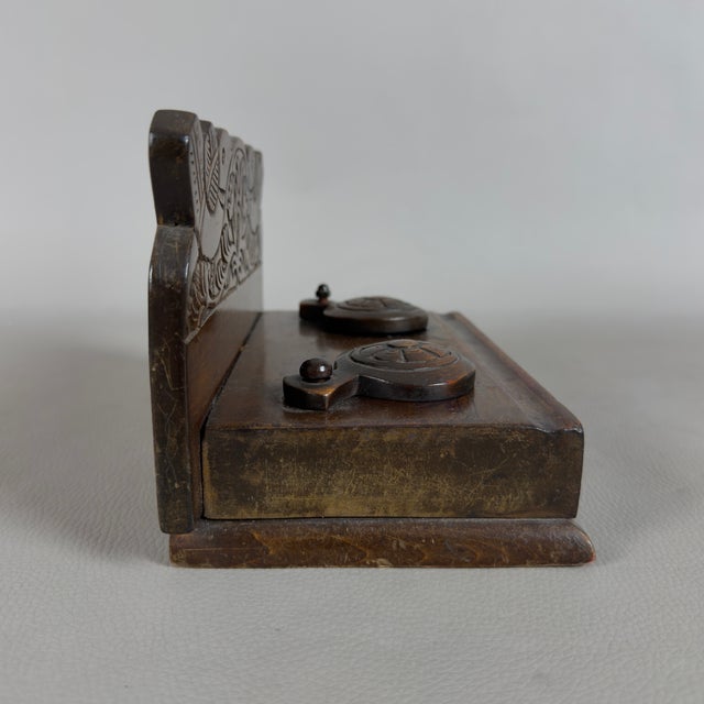 A refined, hand-carved, solid wood double desk inkwell, complete with glass bottles, attributed to artisanal craftsmanship...