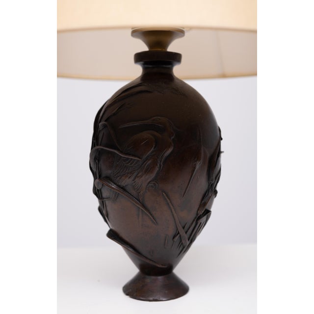 Baluster-shape lamp stand, the bronze vase attractively patinated to a dark reddish-brown finish, finely worked in relief...