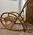 A fun Vintage bamboo and rattan rocking chair with sculptural bent-bamboo arms, woven rattan seat and back, and...