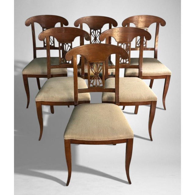 We would first like to point out that five of the six chairs retain their original white fabric upholstery, while one...