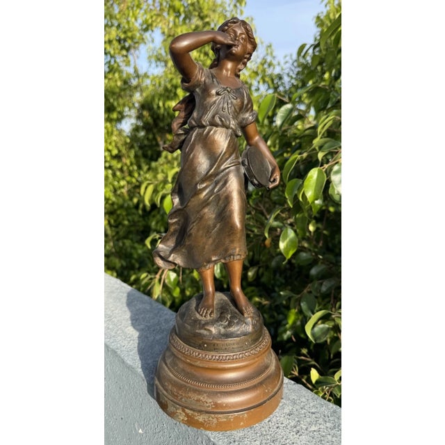 This listing is for an antique cast metal statue titled “Le Baise” by L&F Moreau. The piece depicts a young woman in...