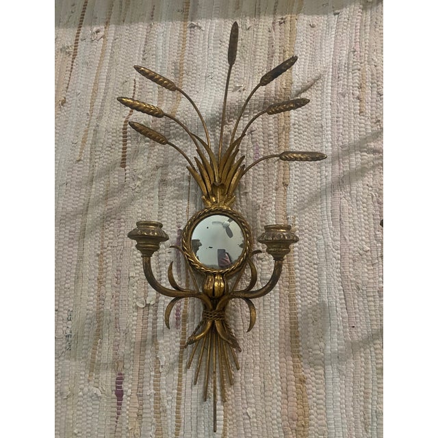This decorative Italian sconce set dates to the mid-century period and is fashioned from gold-toned metal. Each fixture...