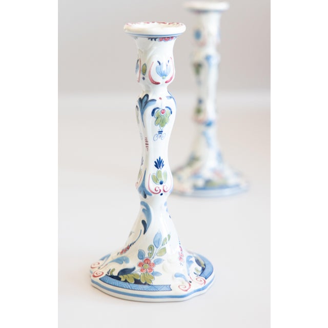 A lovely pair of Mid-Century Dutch Delft faience polychrome candlesticks. Marked "Royal Goedewaagen Blue Delft Holland" on...