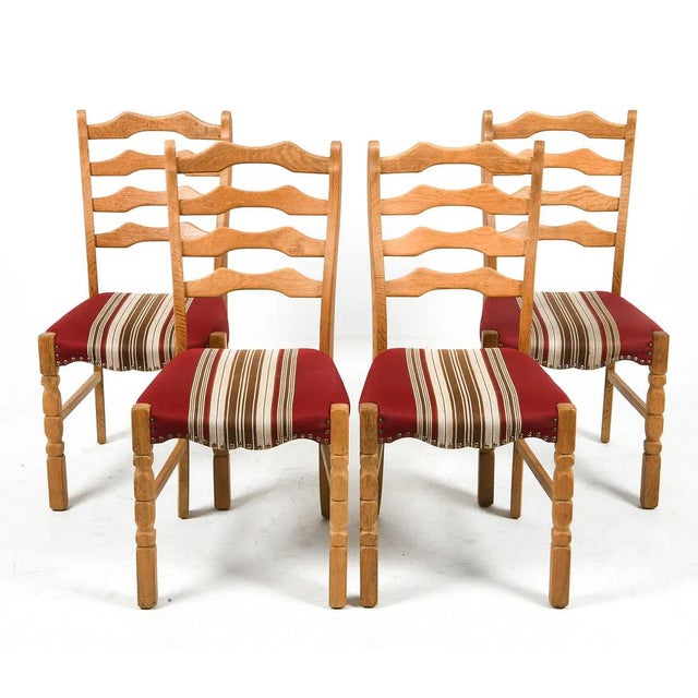 A delightful set of 4 Danish midcentury modern ladder back type dining chairs. The chairs are constructed of oak and are...