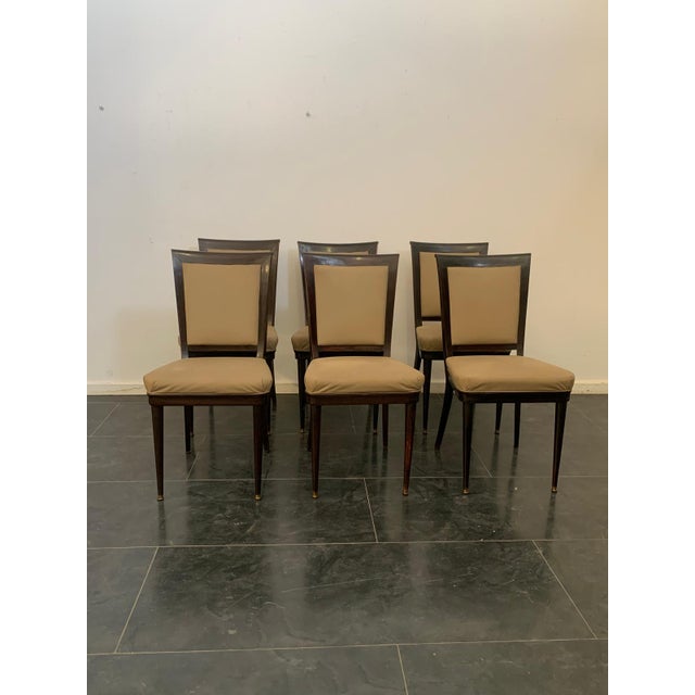 40s/50s Vittorio Dassi chairs in beech dyed brown almost black, thick fake leather, brass tips. This piece is attributed...