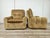 An authentic pair of 1970s armchairs with a soft and generous design, featuring wide rounded armrests, a deep seat, and...