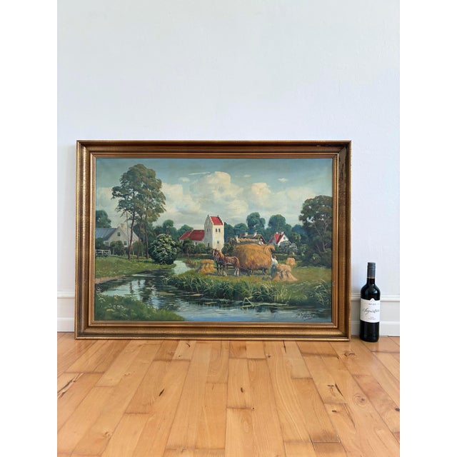 This large original vintage oil painting, from around 1970, shows a peaceful countryside village with cottages, a church...