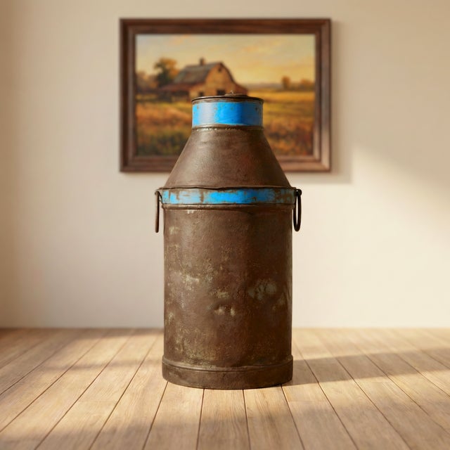 Dimensions: 14" W x 14" D x 29" H This is a vintage milk can or milk churn made from galvanized iron. It wears the...