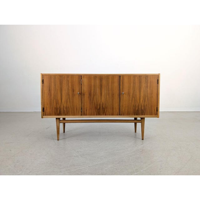 We are offering a beautiful vintage sideboard made of high-quality walnut veneer for sale. Dating from the 1960s, its...