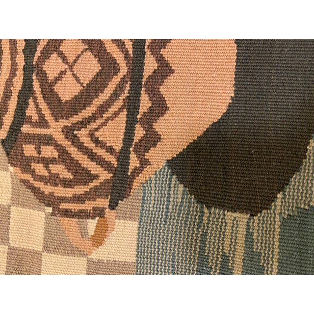 Light brown square needlepoint pillow. It measures 16 x 16 inches. Please note this piece ships flat and without an insert.