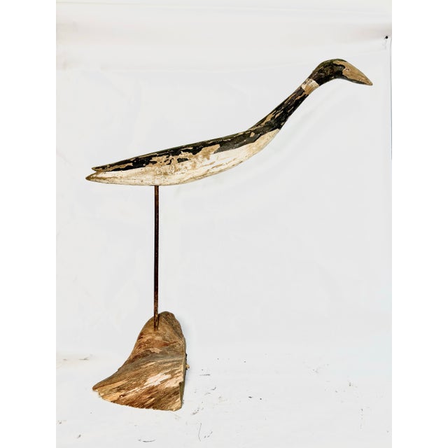 Elegant stylized folk art egret sculpture atop a metal pole and driftwood base. Rotates 360 degrees for perfect placement...