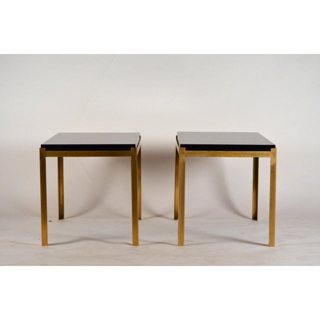 Pair of chic 'Caisson' brass and black lacquer end tables by Design Frères. Solid (not plated) brass frames pared with...