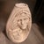 Handcrafted ceramic vase in an off-white color with a matte finish. This piece has two relief-carved Native American faces...