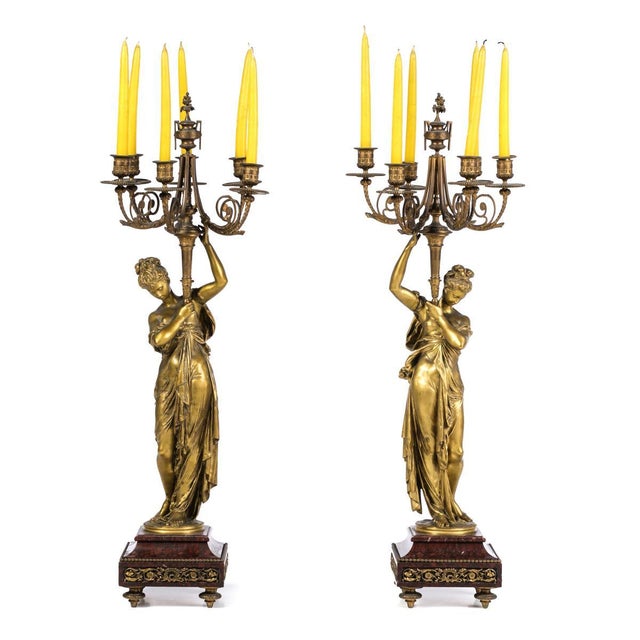 Pair of 19th century French five-light candelabra in gilded bronze. Decorated with female figures, set on a marble base....