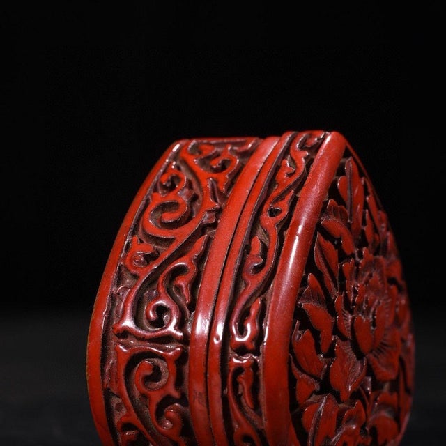 This exquisite vintage trinket box features a stunning deep red lacquer finish with intricate, high-relief carving. The...