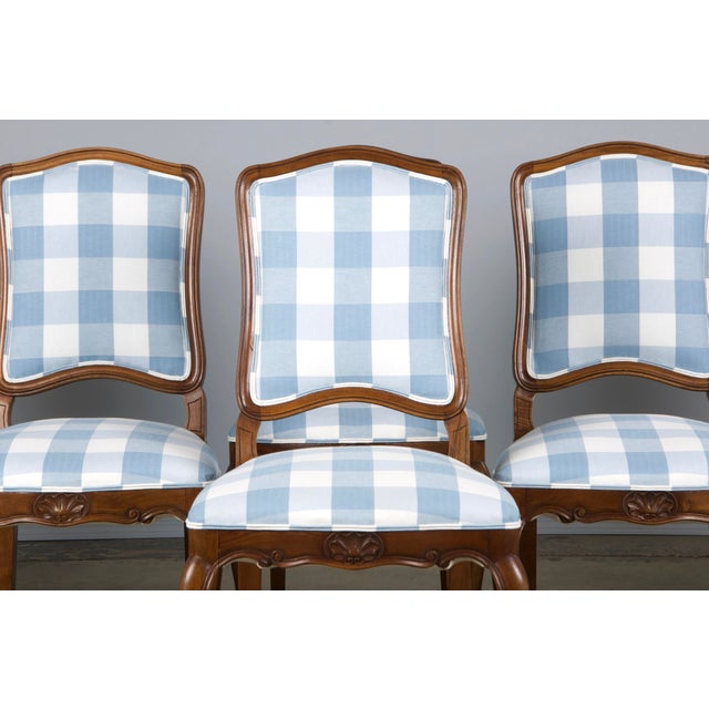 An exquisite set of eight late 19th-century French dining chairs in the Louis XV style, sourced directly from Provence,...