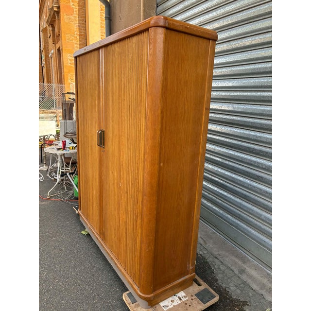 Beautiful oak and oak veneer cabinets. They open and close in the style of tambour door filing cabinets (roll-up...