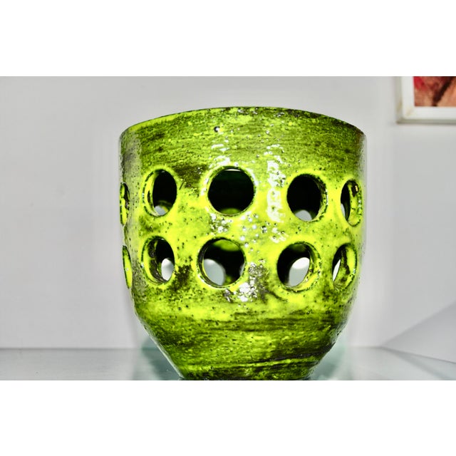 Earthenware ceramic with a green, chamotte glaze, arranged in circles. In 1963, she exhibited her garden ceramics at the...