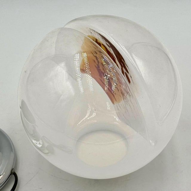 A masterpiece of 70s design, this vintage lamp embodies the era’s artistic innovation. The glass sphere appears divided...