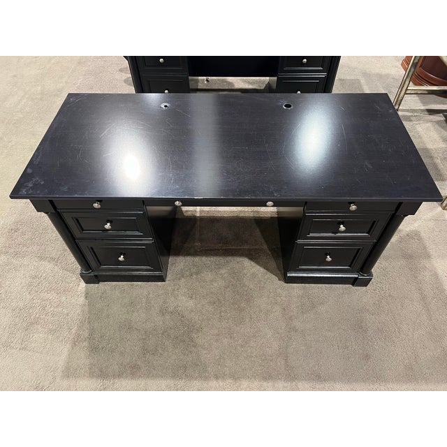 A classic executive desk by Bowery Hill featuring a clean-lined silhouette and a timeless black finish. The spacious...