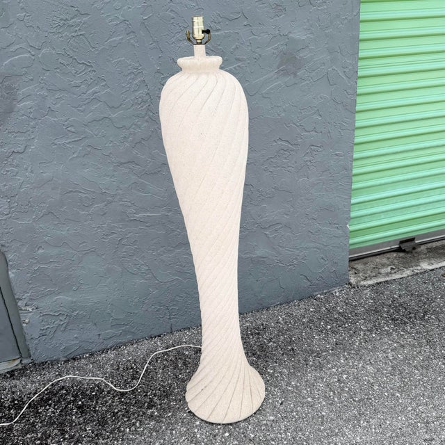 A striking vintage Postmodern floor lamp featuring a tall sculptural body with sweeping spiral fluting from top to bottom....