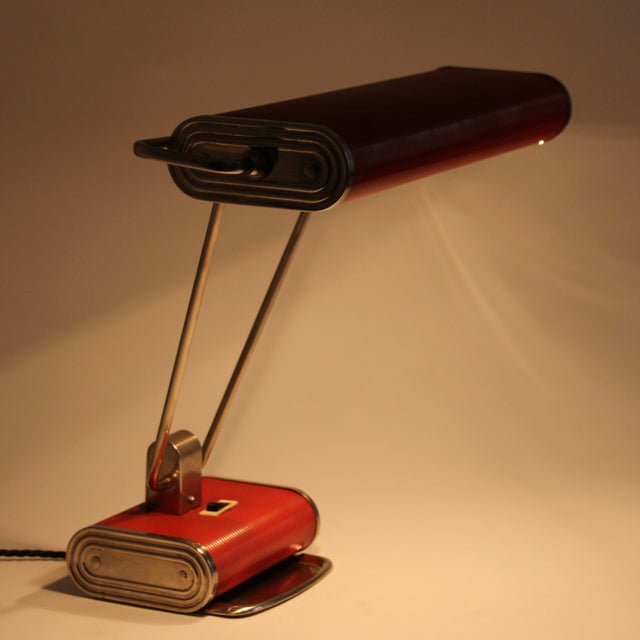 Jumo Model 71! This lamp was designed by Eileen Gray for Jumo in France. It is made from corrugated steel, red painted,...