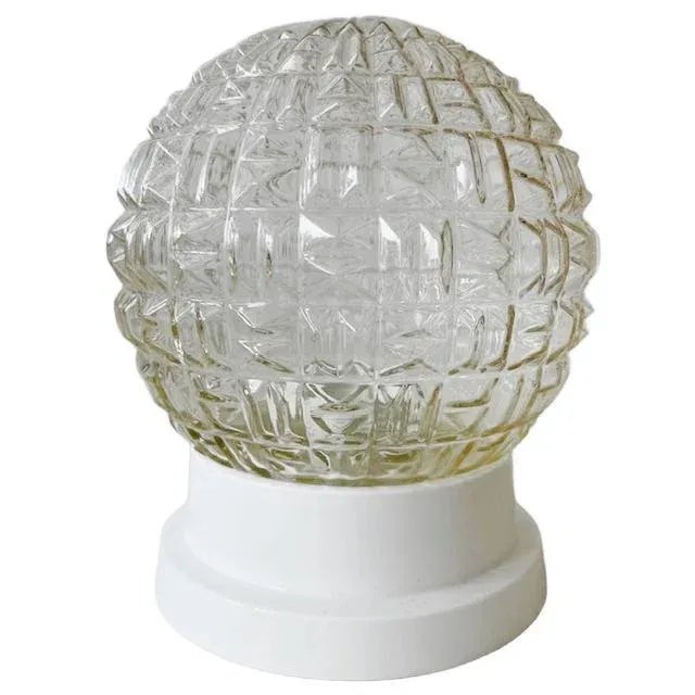 A stunning sixties glass ceiling lamp with a spherical shape from the 1960s. The transparent glass shade has a subtle warm...