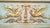 Antiqued ivory-colored trumeau pier mirror with gold leaf finish, accented with a pair of ornately gilded griffins in the...