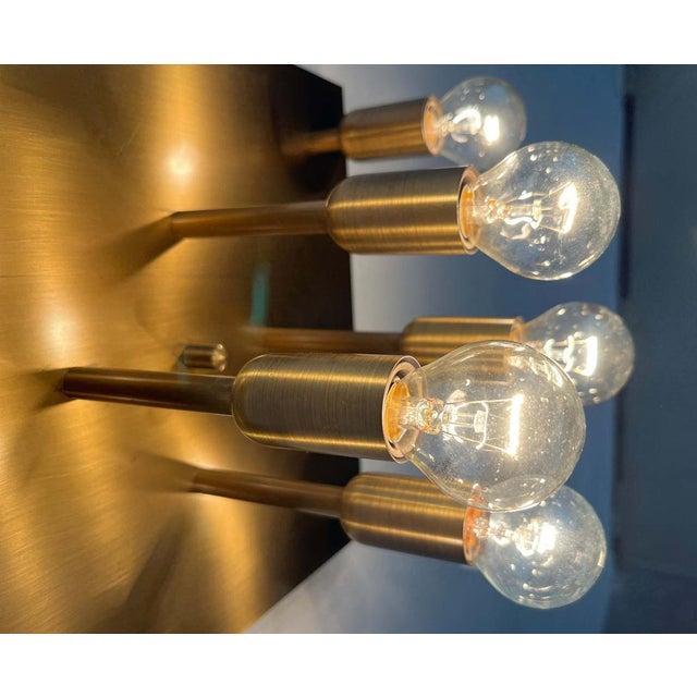 Impressive ceiling/wall light by Sölken. The light has a square base. Eight prongs of varying heights each hold an E14...