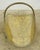 Vintage brass firewood log holder featuring a classic, curved scoop design with an overhead swing handle and decorative...