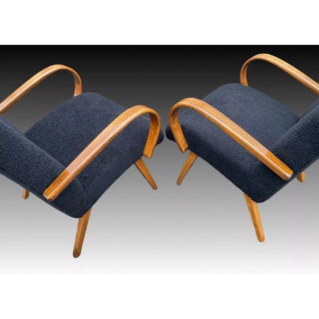 Freshly reupholstered in black fluffy fabric, which adds nice texture to your space. Stable and sound in construction! One...