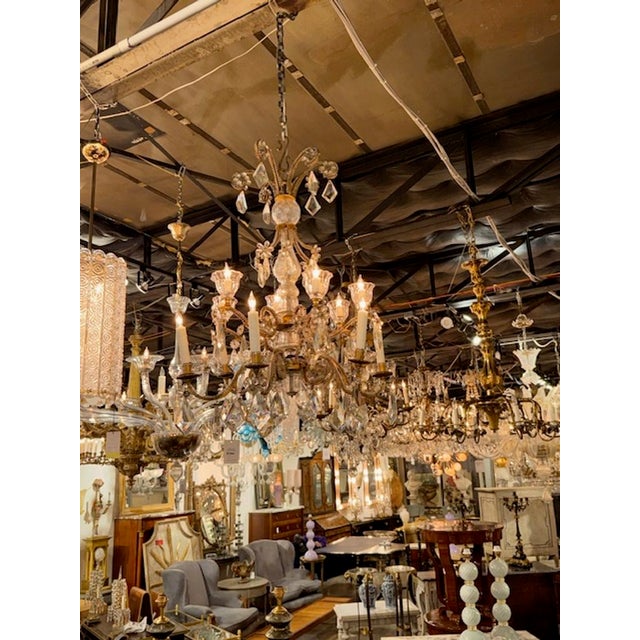 This is an early 20th-century French Maison Bagues chandelier made of gilt bronze and crystal. The chandelier features a...