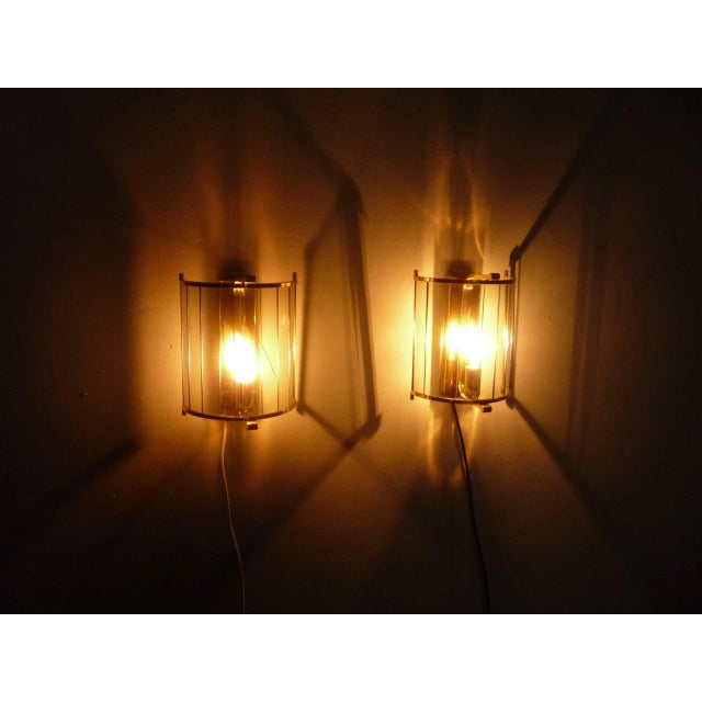 Two fantastic brass wall lamps from Italy. First owner and bought in the early 1960s. Material brass and tinted glass....