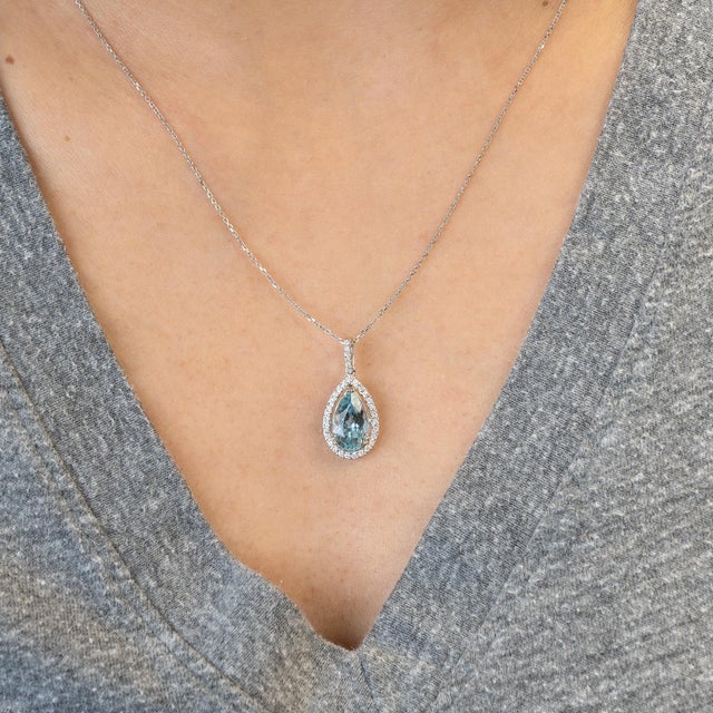 A stunning 2.1ct aquamarine (12x7mm) radiates serene ocean-blue brilliance, accented with natural diamonds and set in...