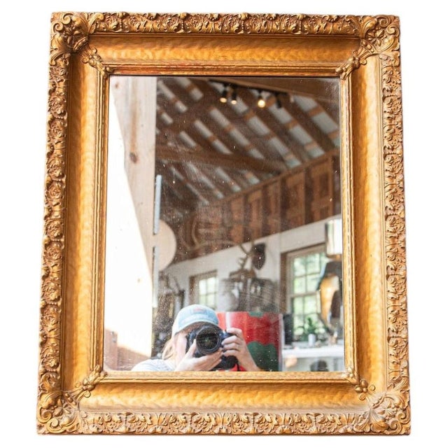 foliate ornamentation. The frame displays a refined balance of high-relief detailing at the corners with a delicately...