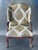 This is a traditional upholstered armchair with classic Georgian/Queen Anne–inspired detailing. The chair features a tall,...