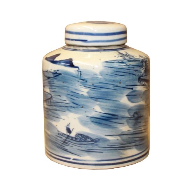 This is a handmade ceramic container urn jar in the white base color. The surface has a blue color oriental scenery...