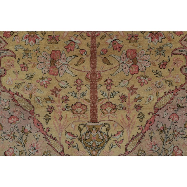 Hand-knotted in silk, circa 1920-1929, this rare 4x6 antique Persian Qum rug highlights a breathtaking tree of life and...