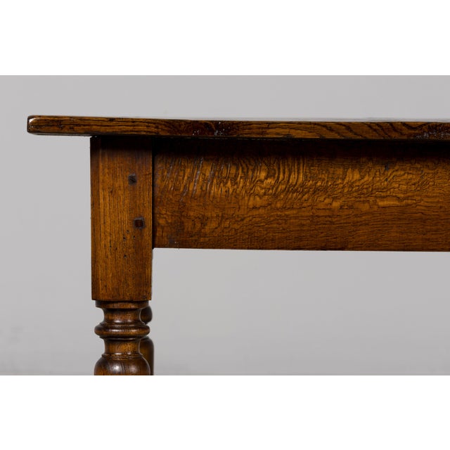 A mid-19th-century French Provincial oak writing table in the Louis Philippe style, sourced in Provence, France. The table...