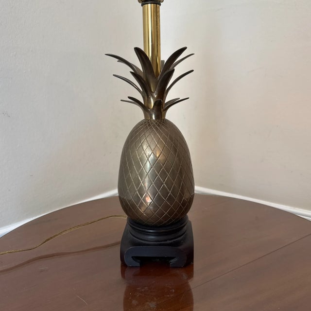 Beautiful large brass pineapple lamp on wooden base. Minor wear and patina consistent with age. In working condition with...