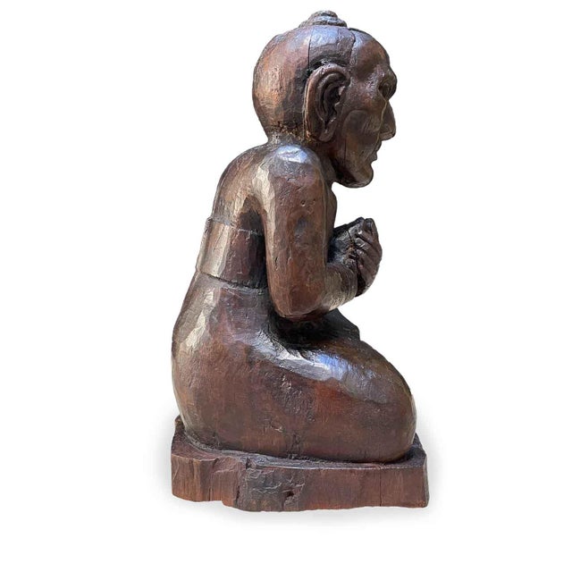 Burmese Monk Carved in Wood, early 1900s, oriental sculpture crafted from a single piece of wood, wax-restored with a dark...