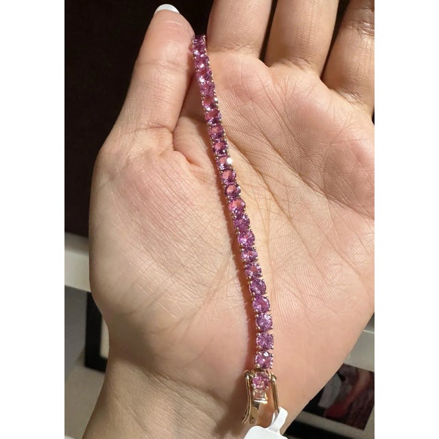 This is part of Chairish’s Fine Jewelry assortment. This Brilliant Pink Sapphire Tennis Bracelet in 14K gold showcases...