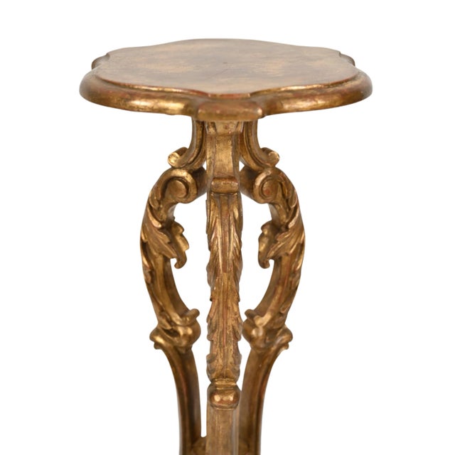A luxury pair of vintage Italian giltwood pedestals or plant stands feature tripod bases with scrolled cabriole legs and...
