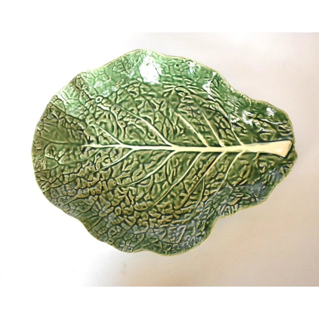 A vintage large serving bowl or platter in the trompe l'oeil cabbageware form of a green and white cabbage leaf, made in...