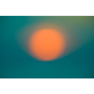 A Farewell to Day 7.2 by Tal Paz-Fridman | Photography of a blurred orange sun on a teal background For Sale